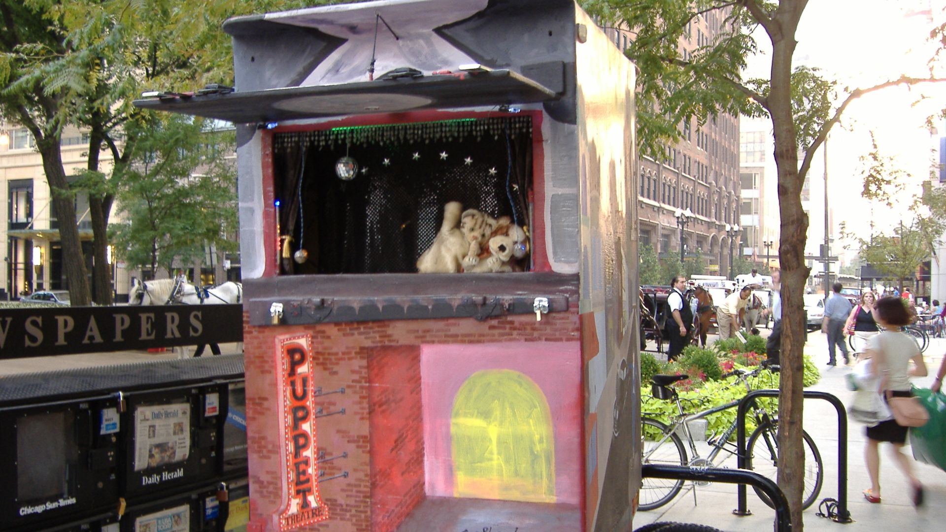 Travelling puppet show on Chicago & Michigan.

Update: Here's a better shot, taken a few months later. There weren't any kids watching when I took this one.