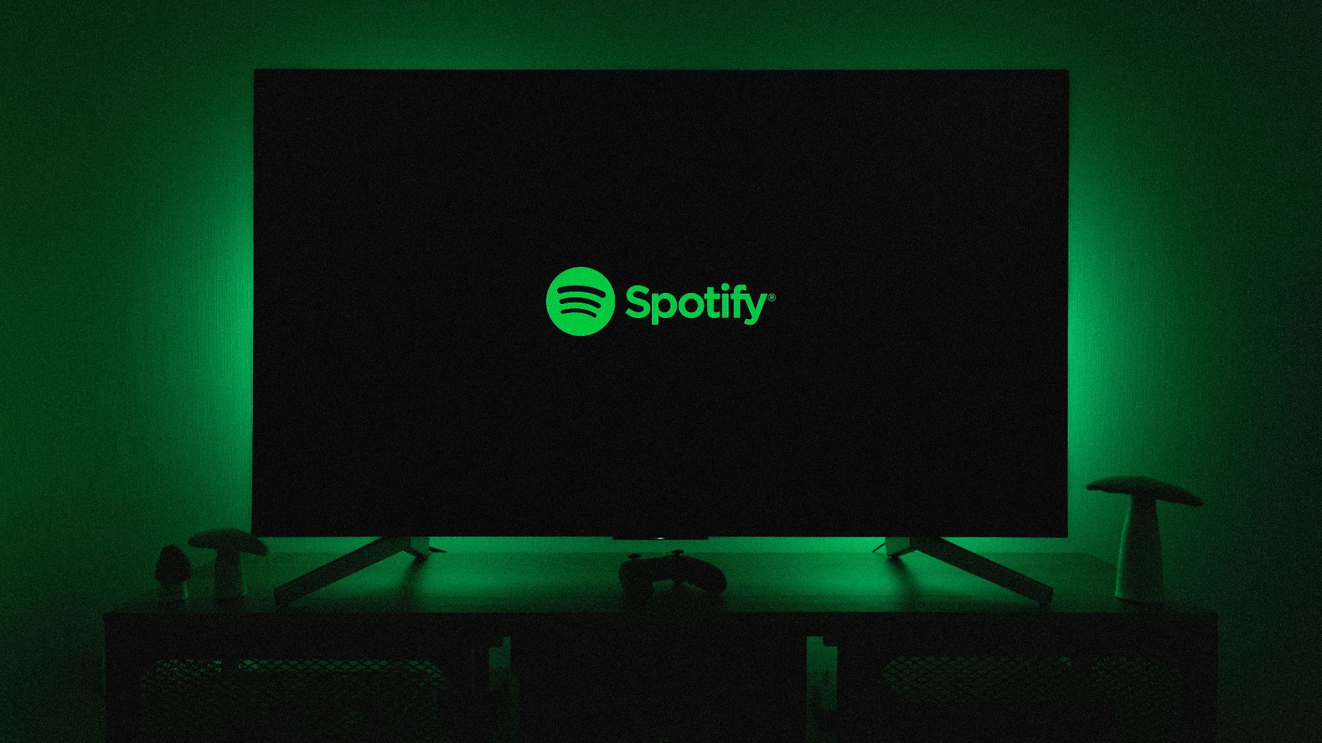 the spotify logo is lit up on a flat screen tv