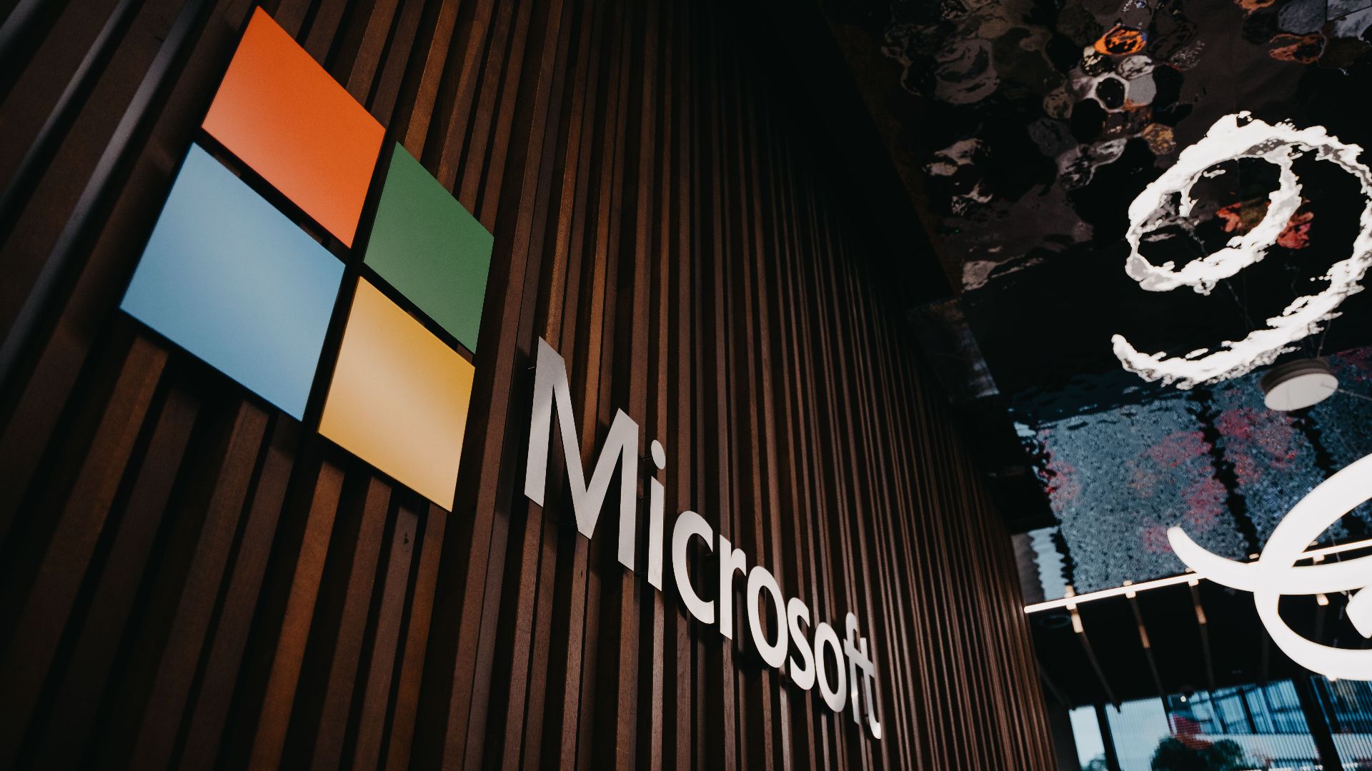 Interior view of Microsoft office with logo on wooden wall in Brussels, Belgium.