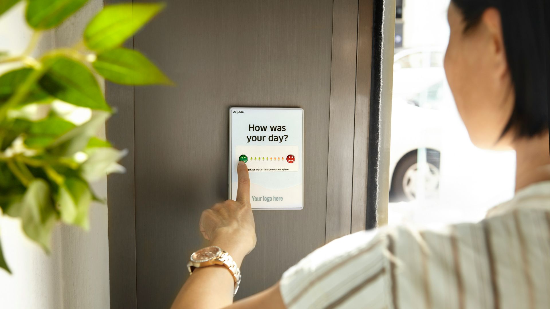 person holding white card near green plant