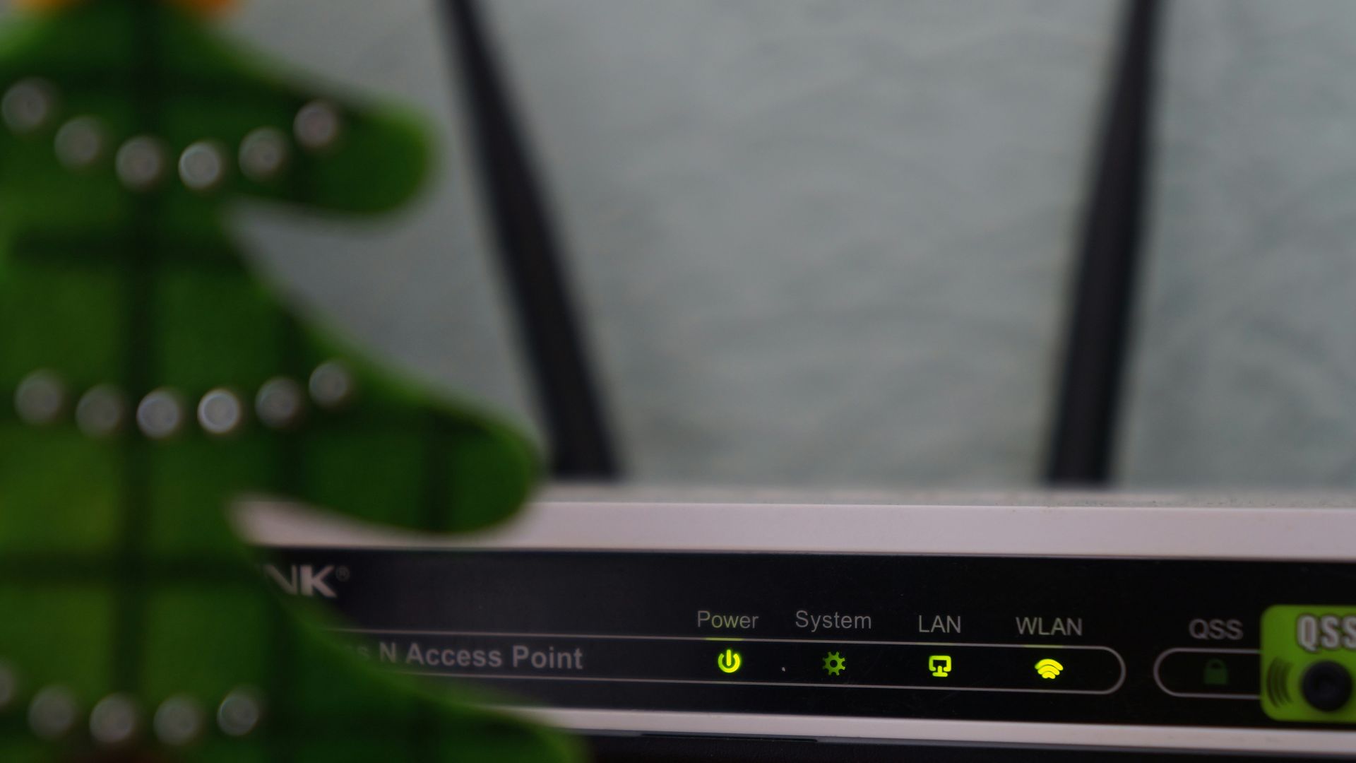 white and black modem router with four lights