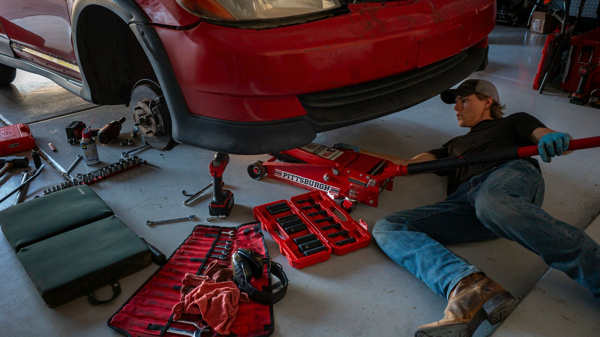 a man working on a car in a garage