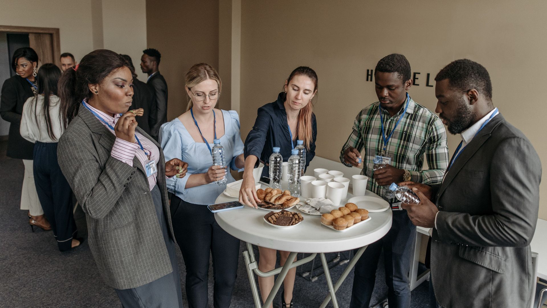 Prominent business professionals networking and enjoying refreshments at a conference.