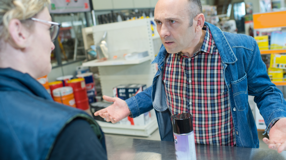 Aggressive customer at shop counter yelling