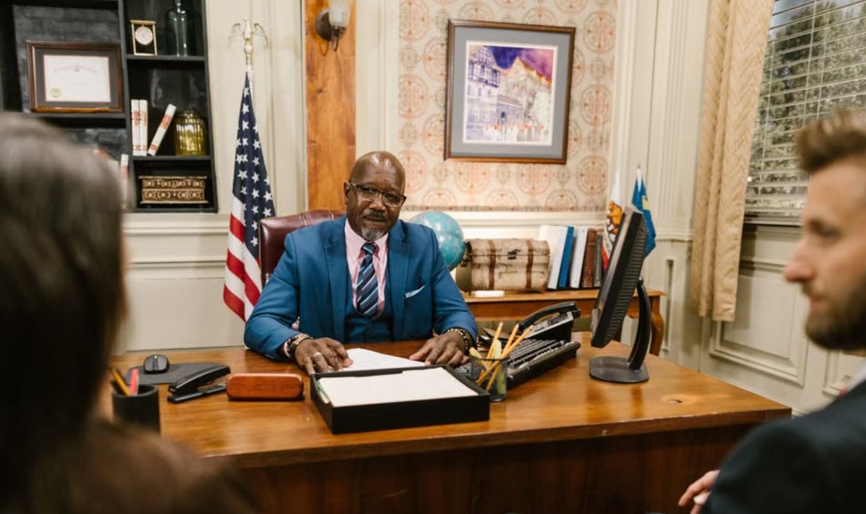 A professional lawyer meeting with clients in his office at a legal consultation