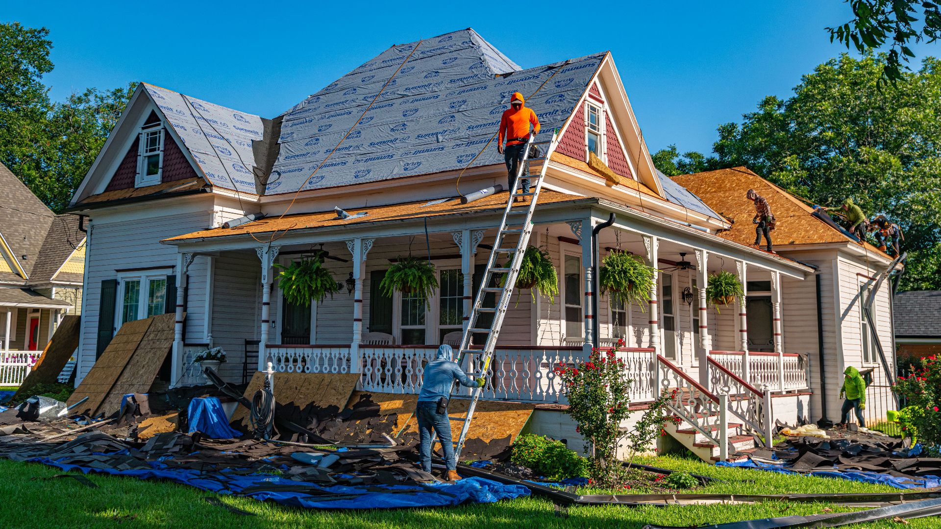 Roofers replace the roof of a historic home in Weatherford, Texas.