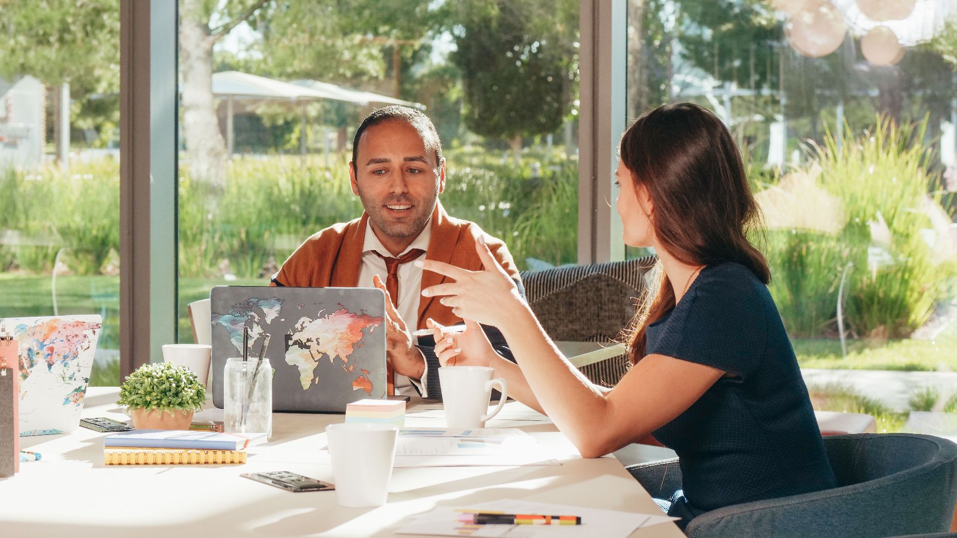 Business professionals discussing strategy in a bright, modern office setting.