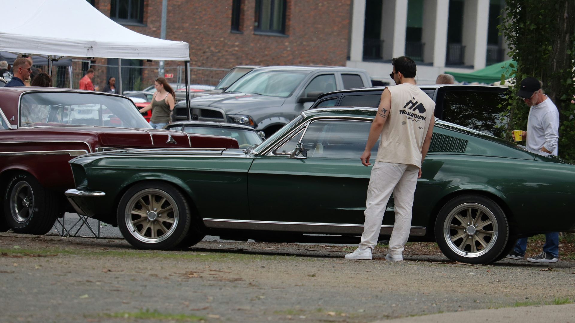 Classic green ford mustang fastback parked outdoors