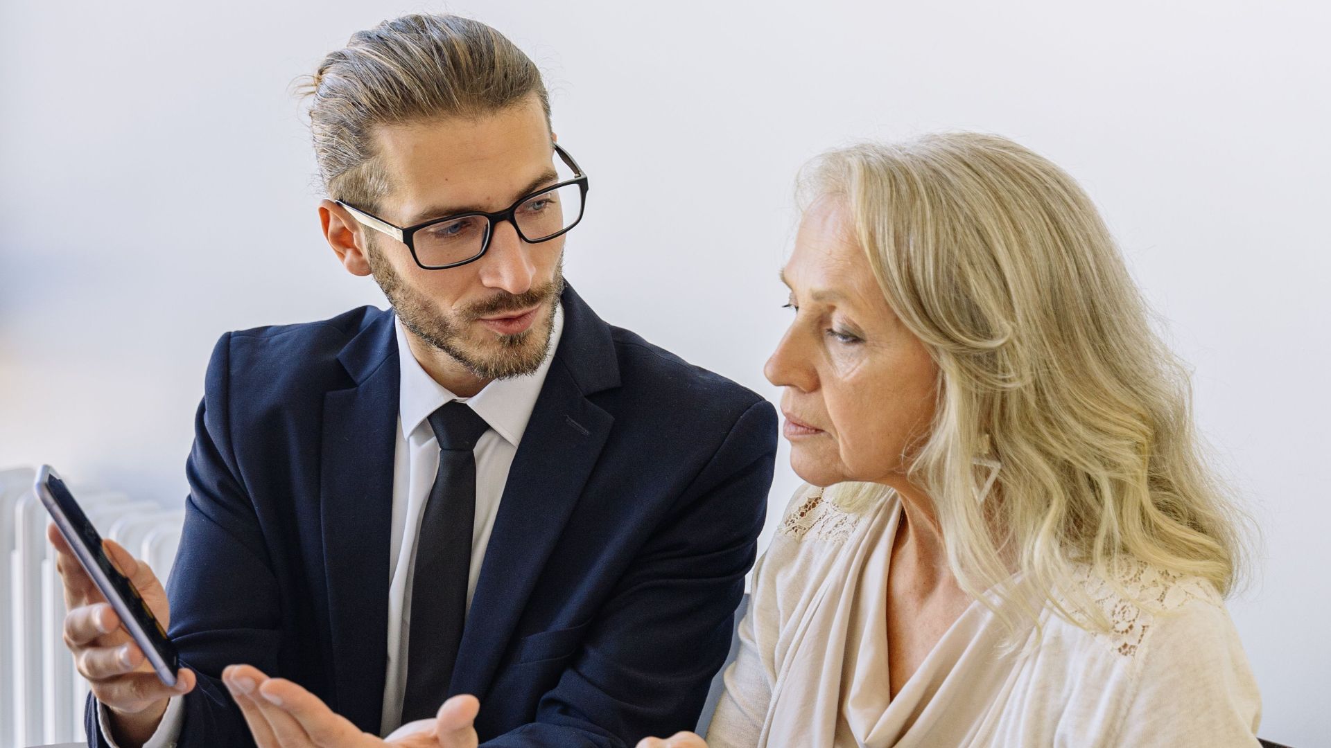 Professional business discussion between a consultant and client in an office setting.