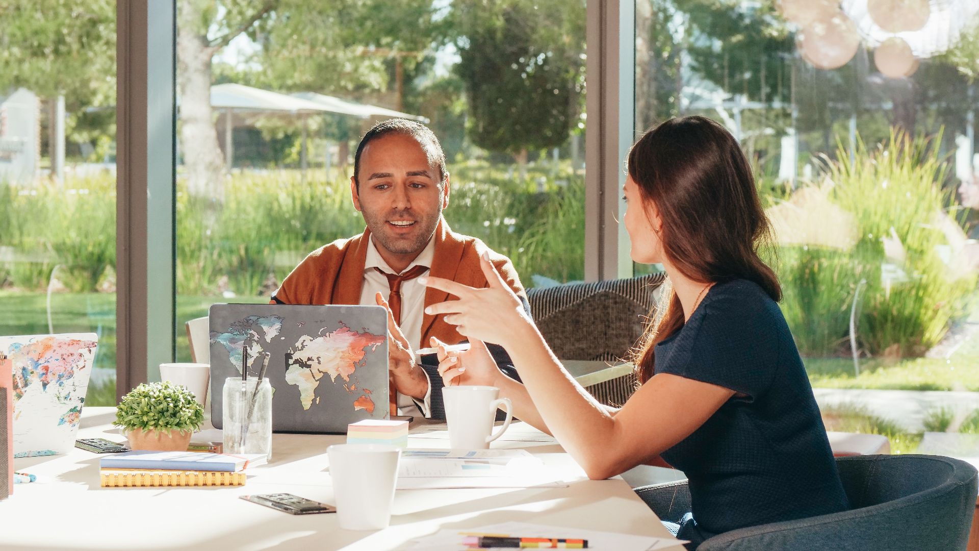 Business professionals discussing strategy in a bright, modern office setting.