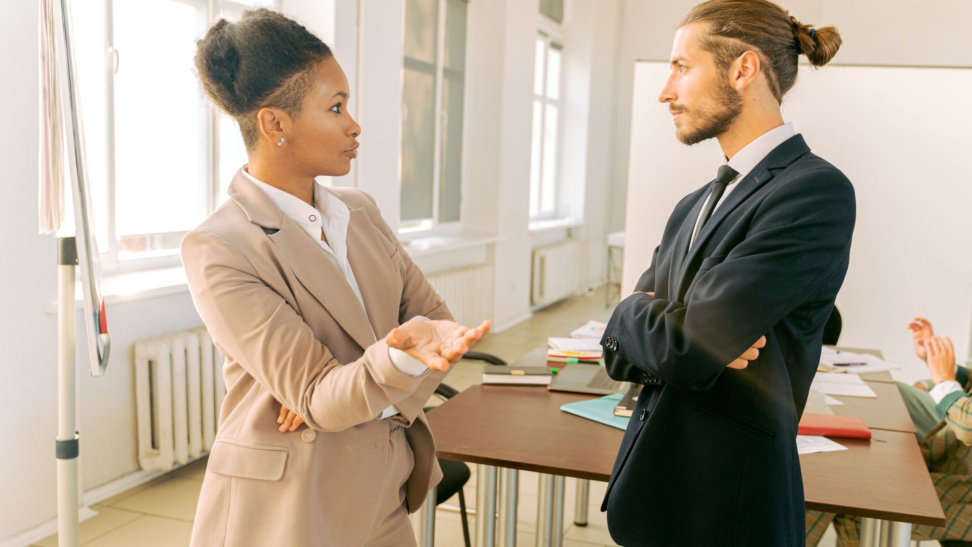 Business professionals in conversation during a meeting in a modern office environment.