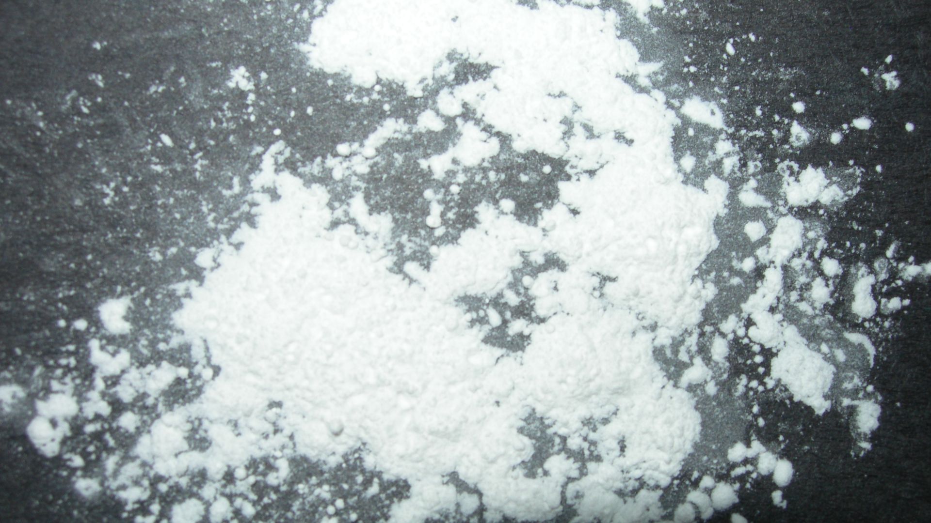 Talcum powder on black construction paper for contrast.