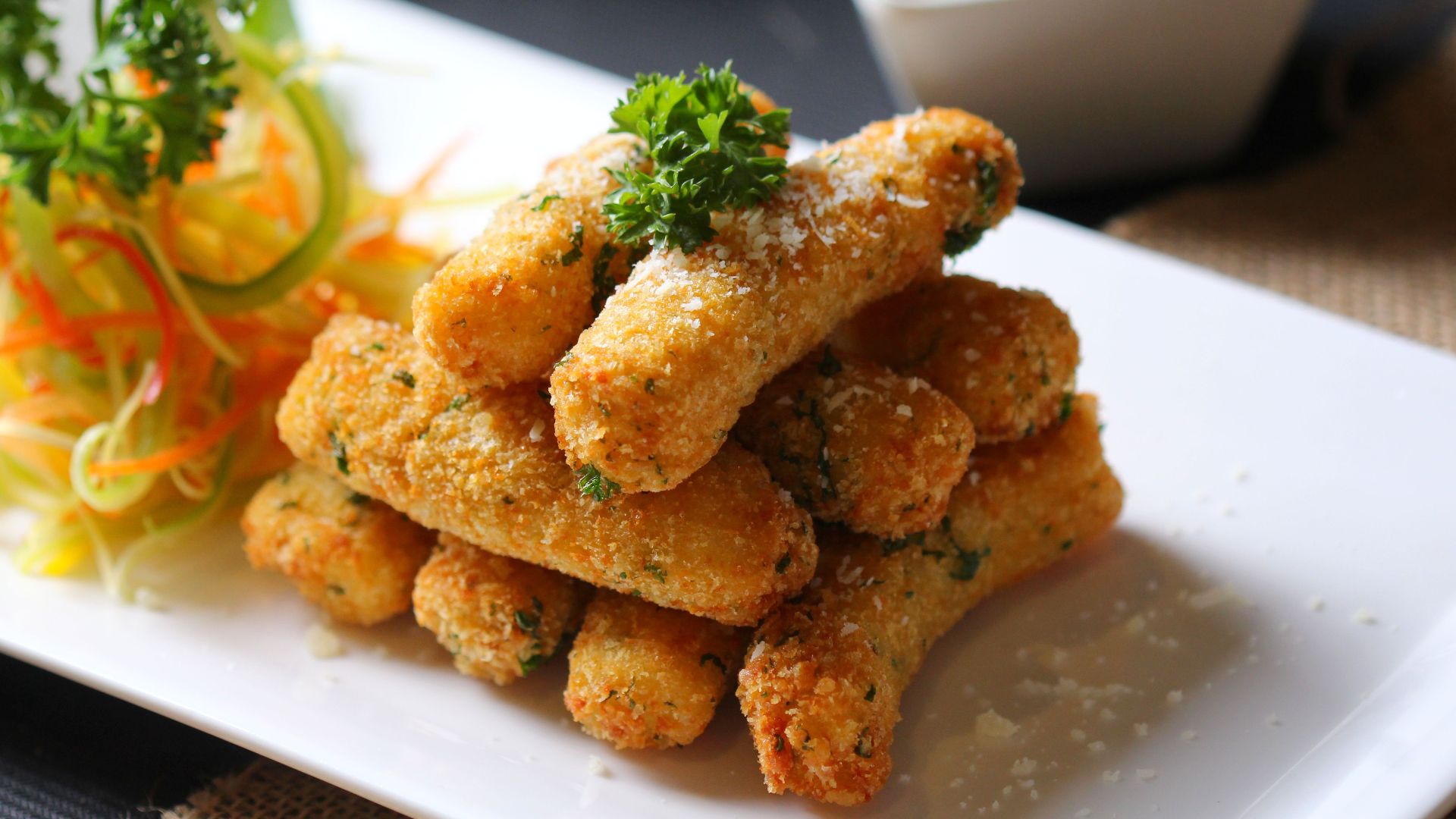 Delicious crispy mozzarella sticks served with fresh vegetable salad and creamy dipping sauce.