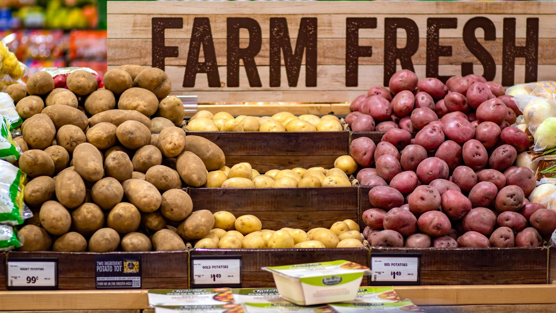 Various farm fresh potatoes displayed in a grocery store