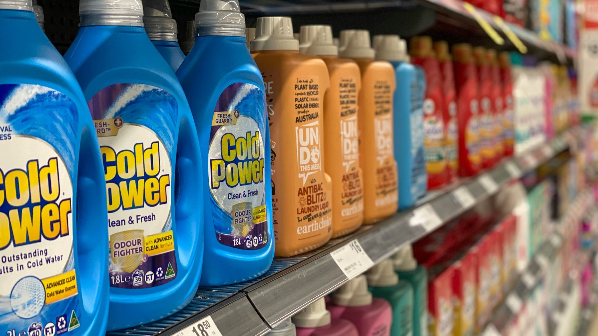 bottles of cold power on a shelf in a store