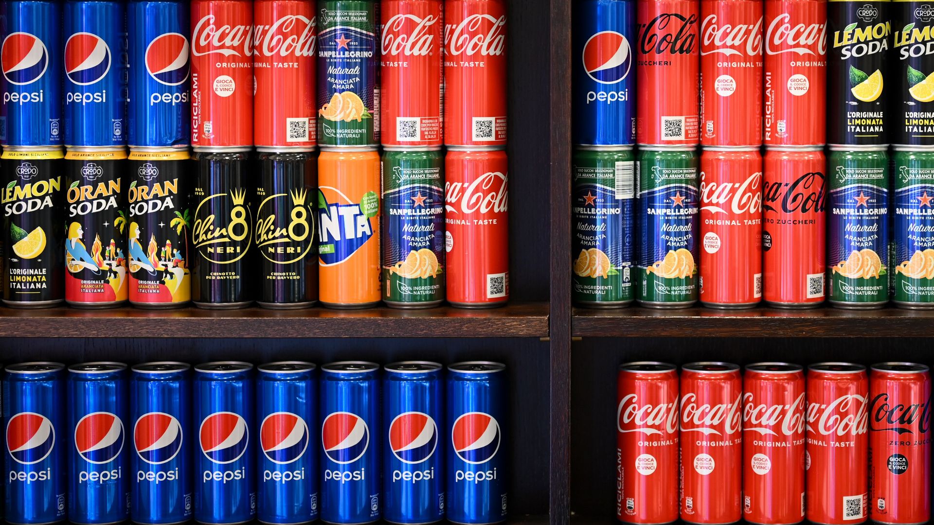 Colorful display of assorted soft drinks and wines on store shelves in Rome.