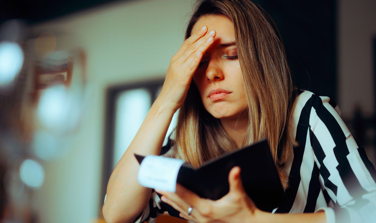 Unhappy Woman Receiving an Overpriced Bill in a Restaurant. Unhappy customer getting an inflated check at the diner 