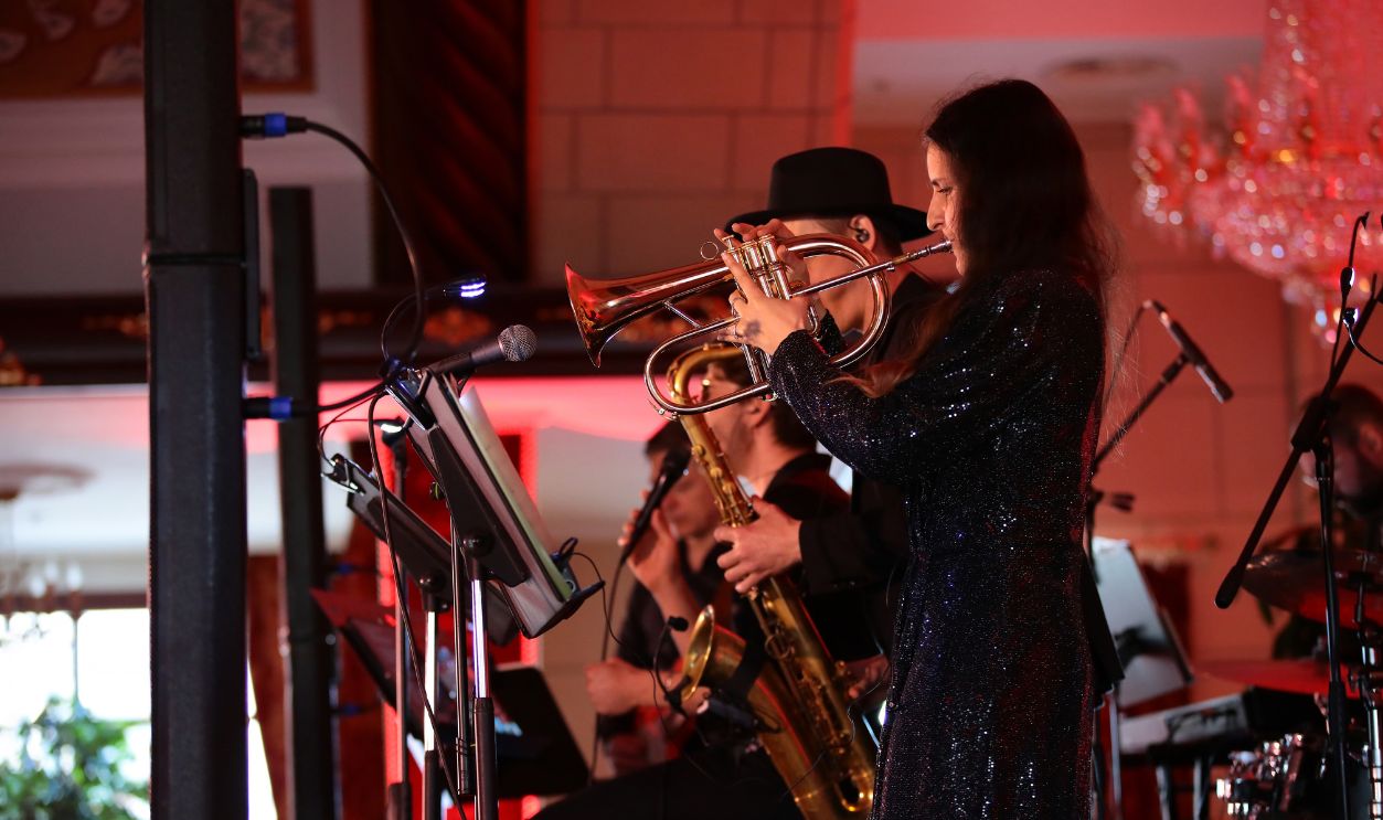 Concert jazz band playing on stage on brass trumpet saxophone