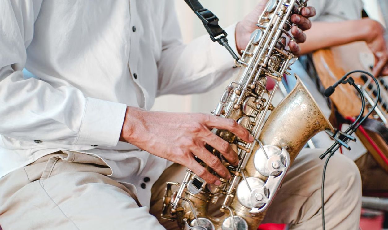 Detailed shot of a musician playing a saxophone during a performance. Captures the essence of live music