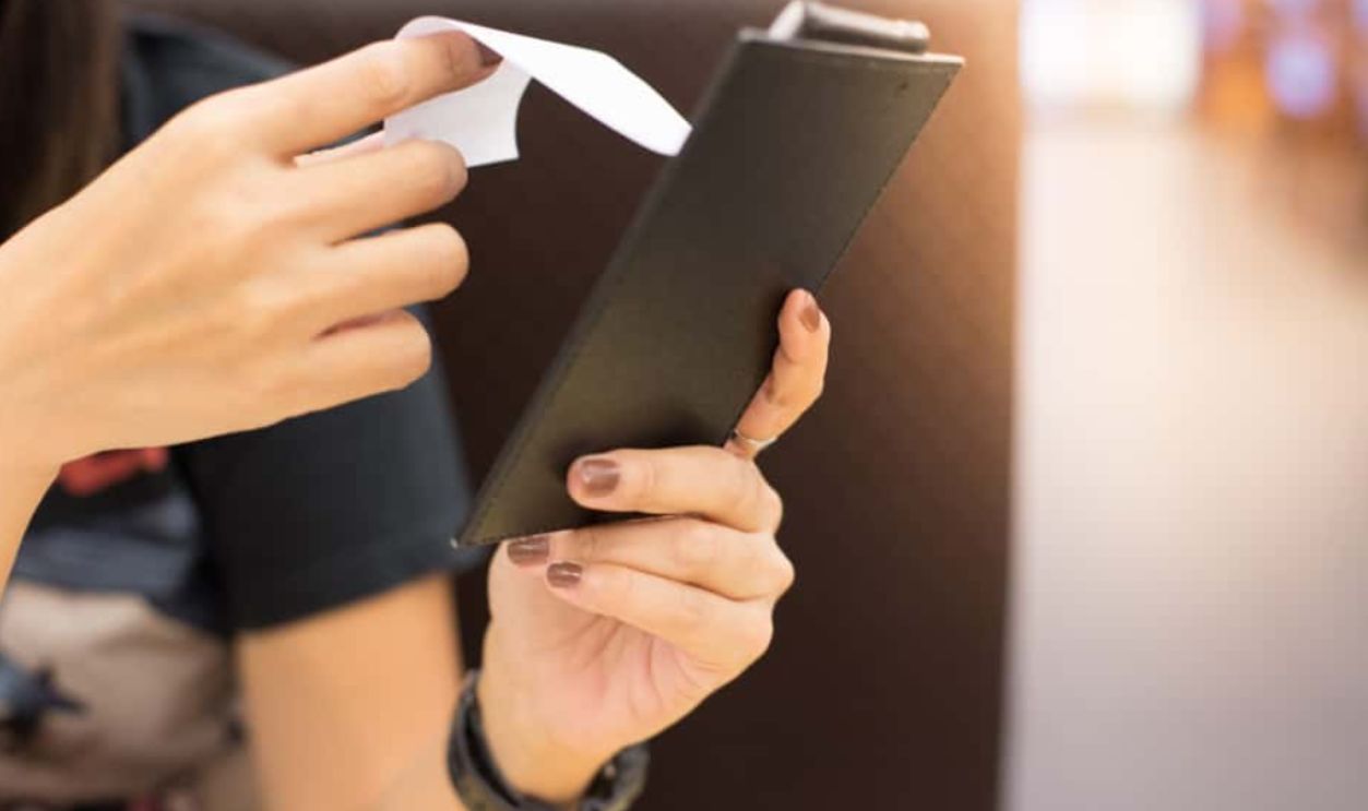 Women are reading food bill in the restaurant