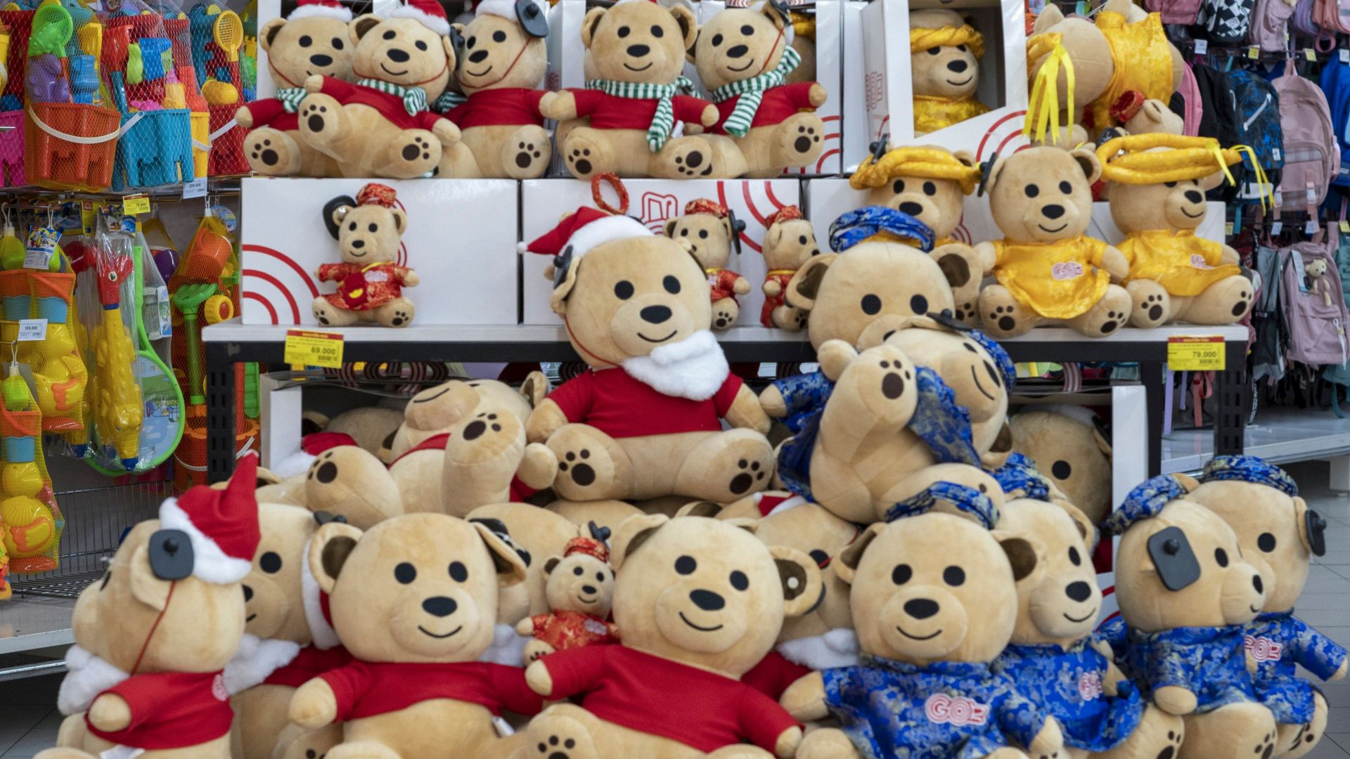 Colorful teddy bear display in a retail store offering special promotions.