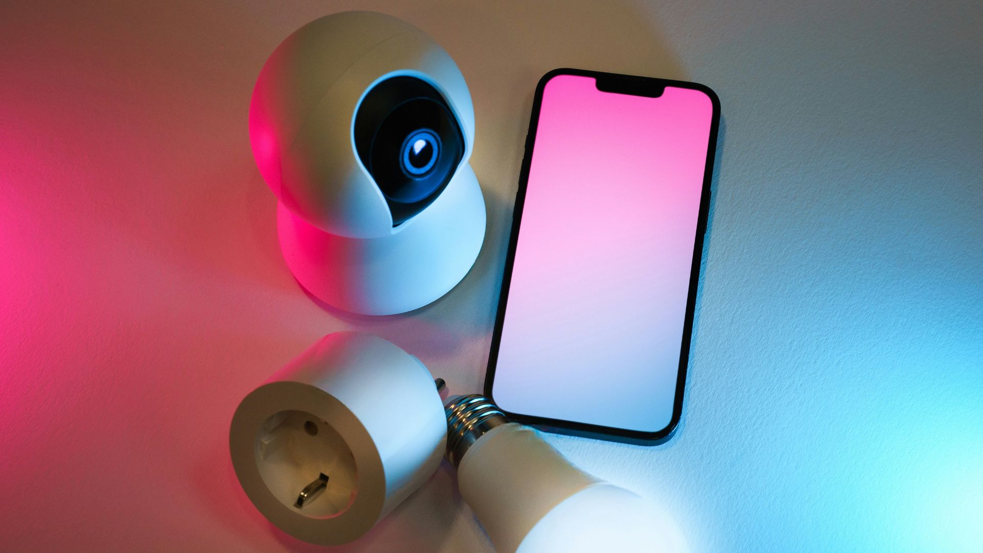 A smart phone sitting on top of a table next to a flashlight