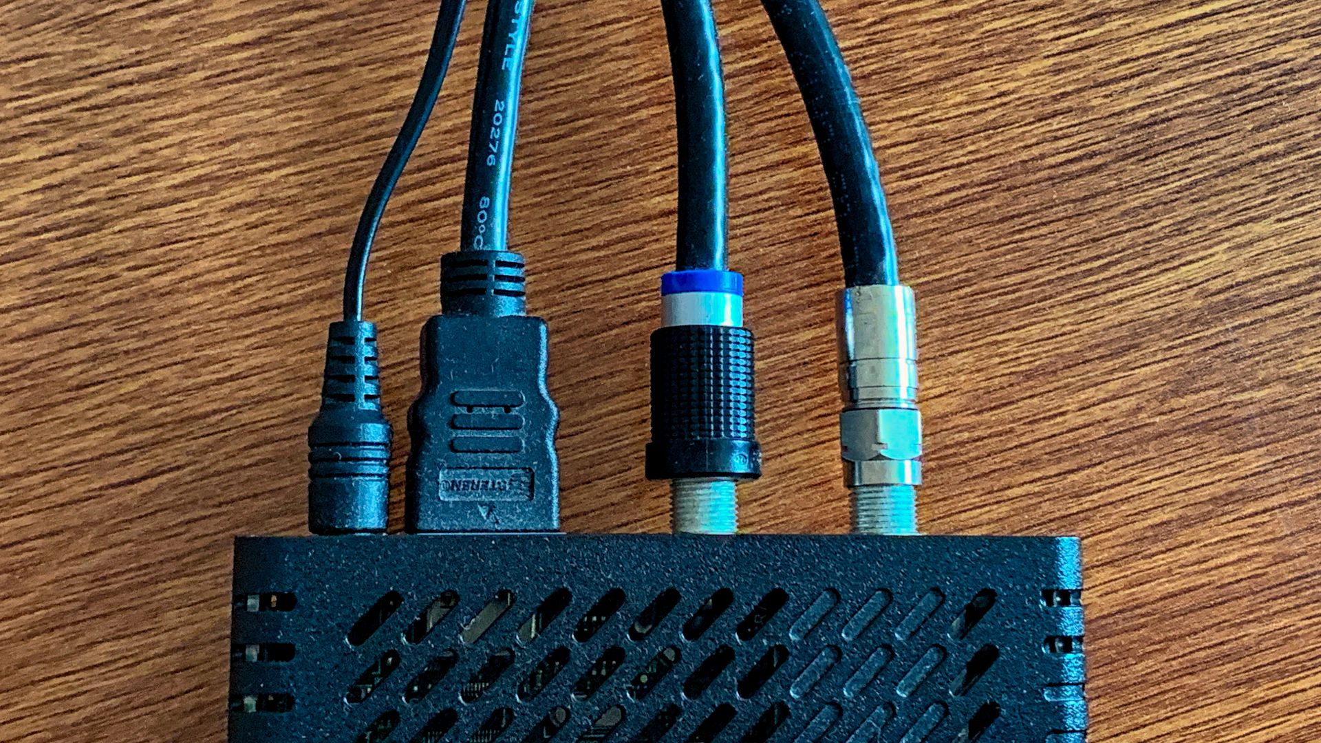 A Mediacom Pace DC60Xu high definition (HD) television (TV) (HDTV) digital transport adapter (DTA) digital adapter cable box. The device has a coaxial cable TV line in and HDMI video out.
