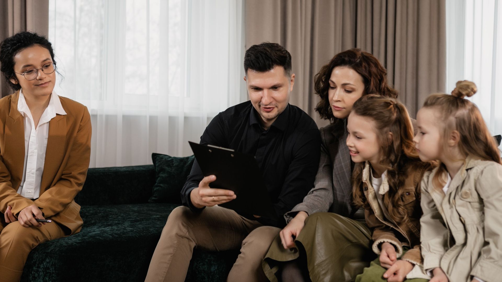 A family receiving advice from a professional advisor indoors, focused on financial planning.