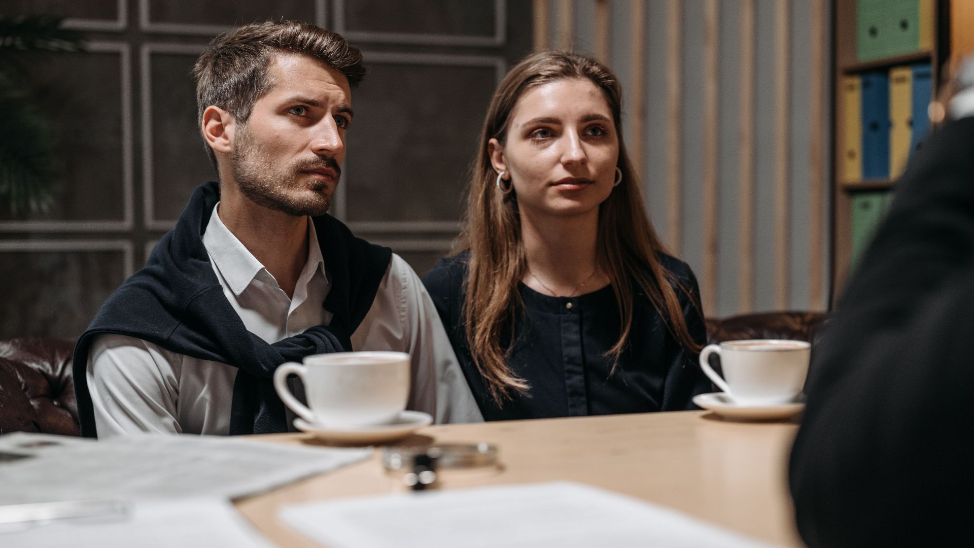 Business meeting with a couple engaging with a consultant in a modern office setting.