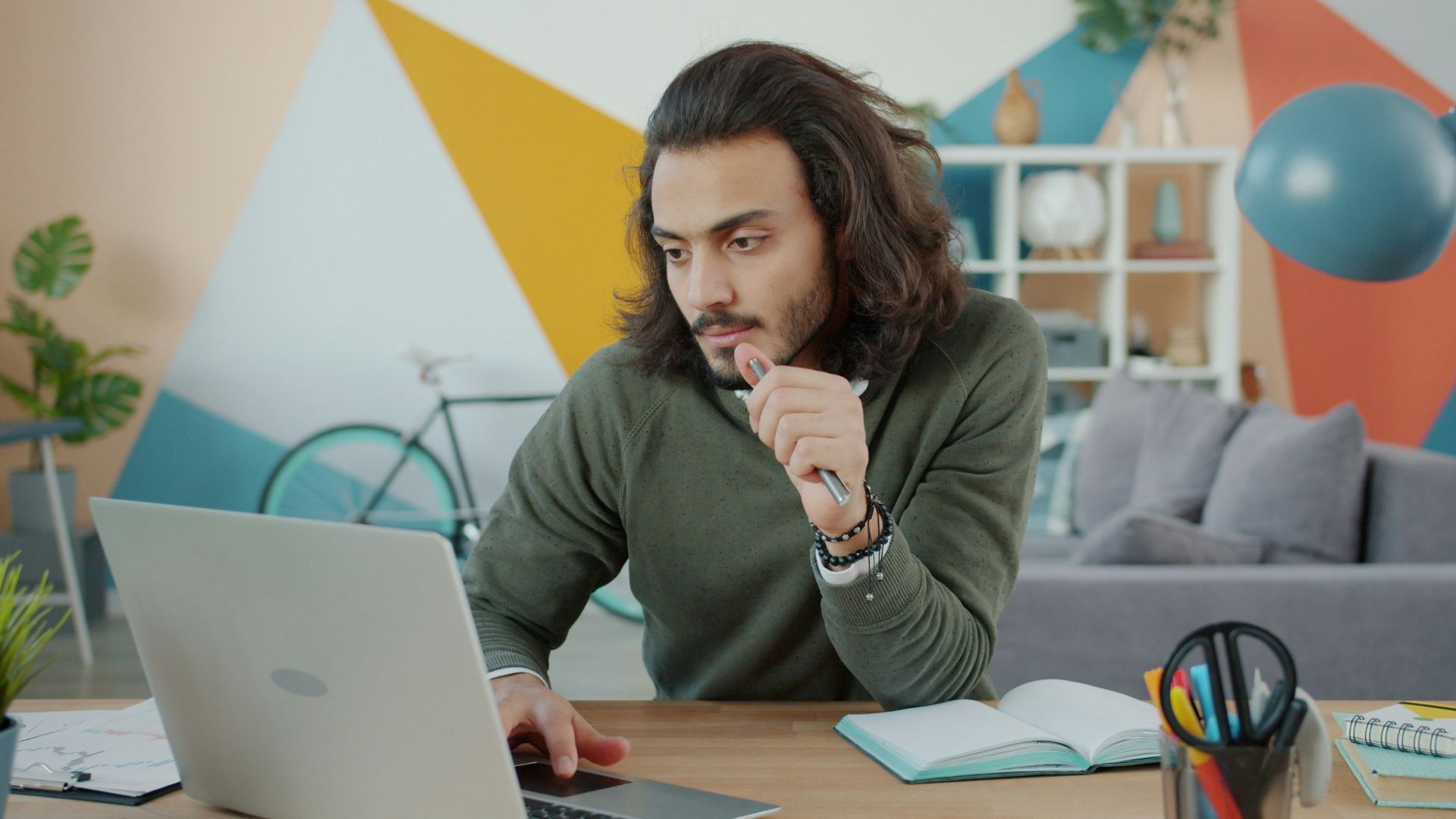 Man working on laptop in colorful modern office