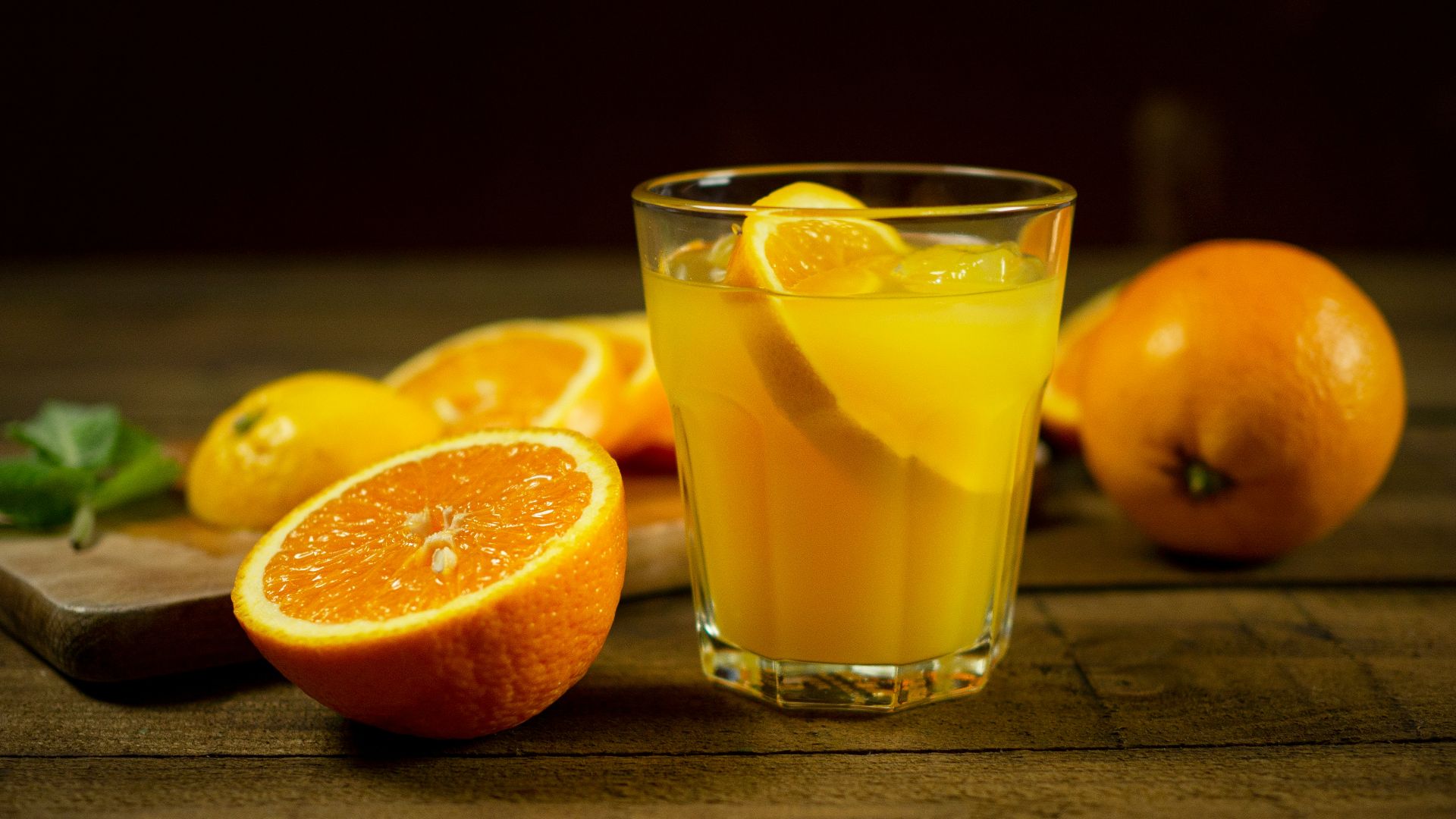 orange juice in clear drinking glass
