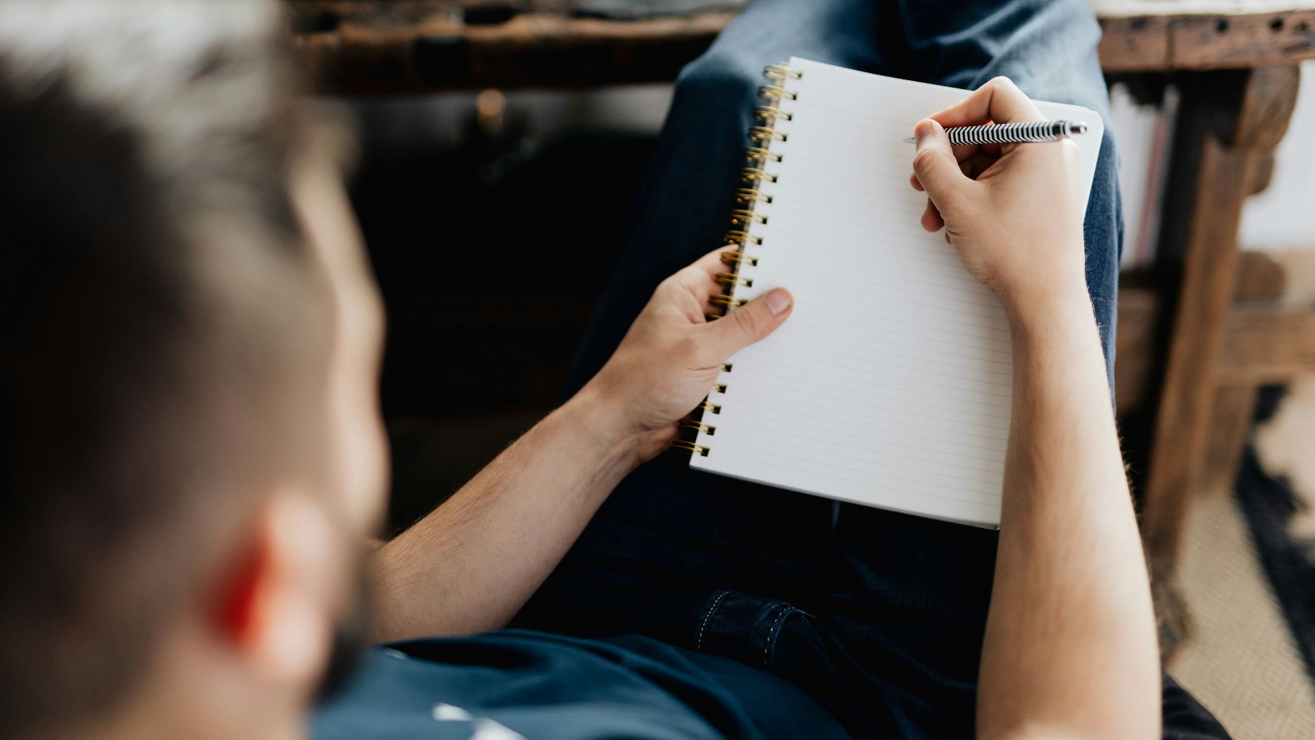 a person writing on a piece of paper