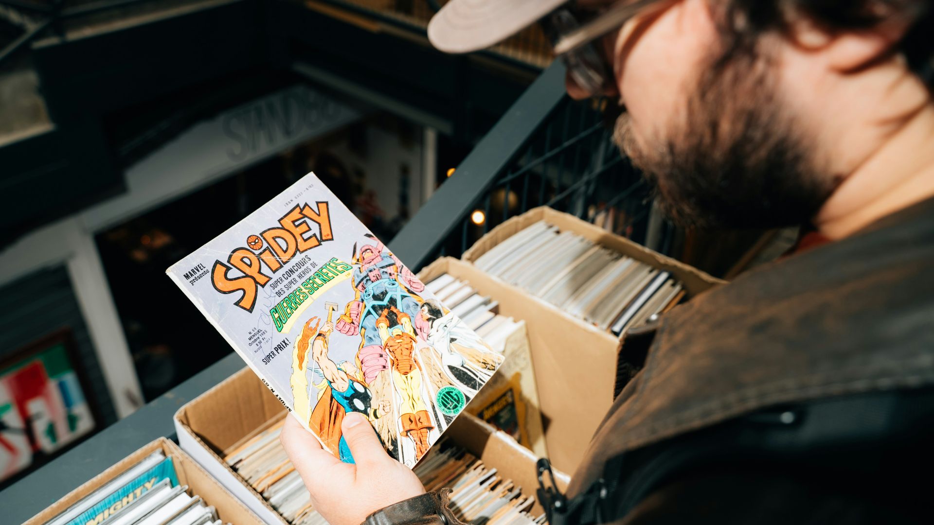 Man looking at a spidey comic book in a bin