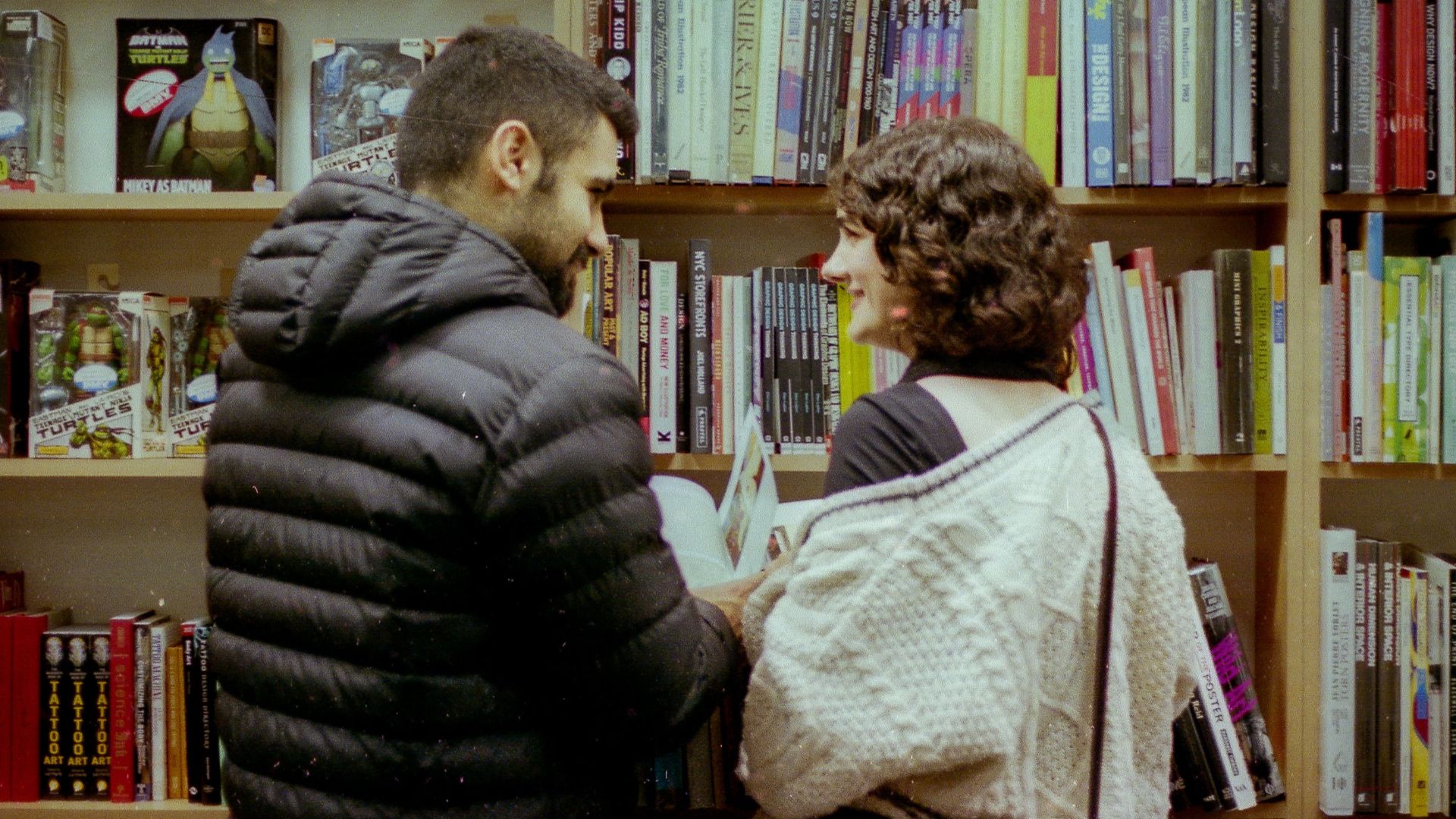 A couple enjoys a quiet moment browsing books in a Toronto bookstore.