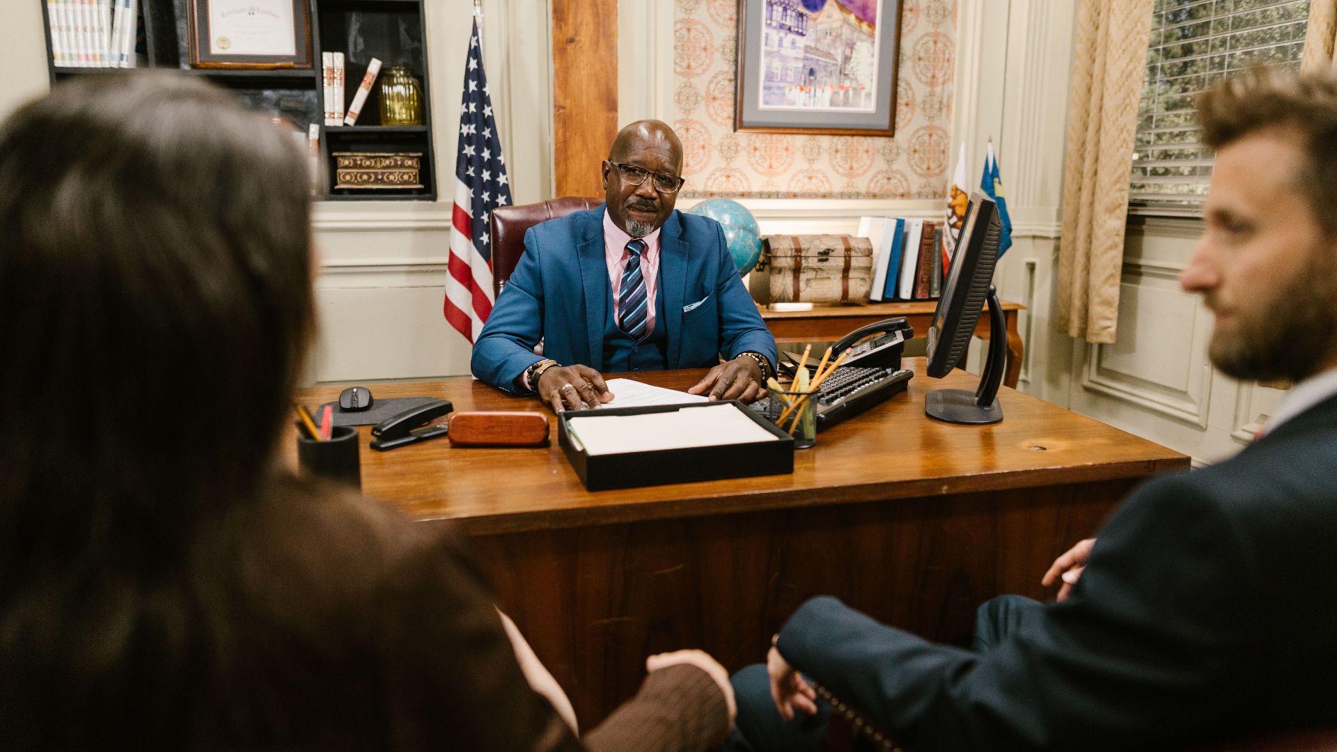 A professional lawyer meeting with clients in his office at a legal consultation.