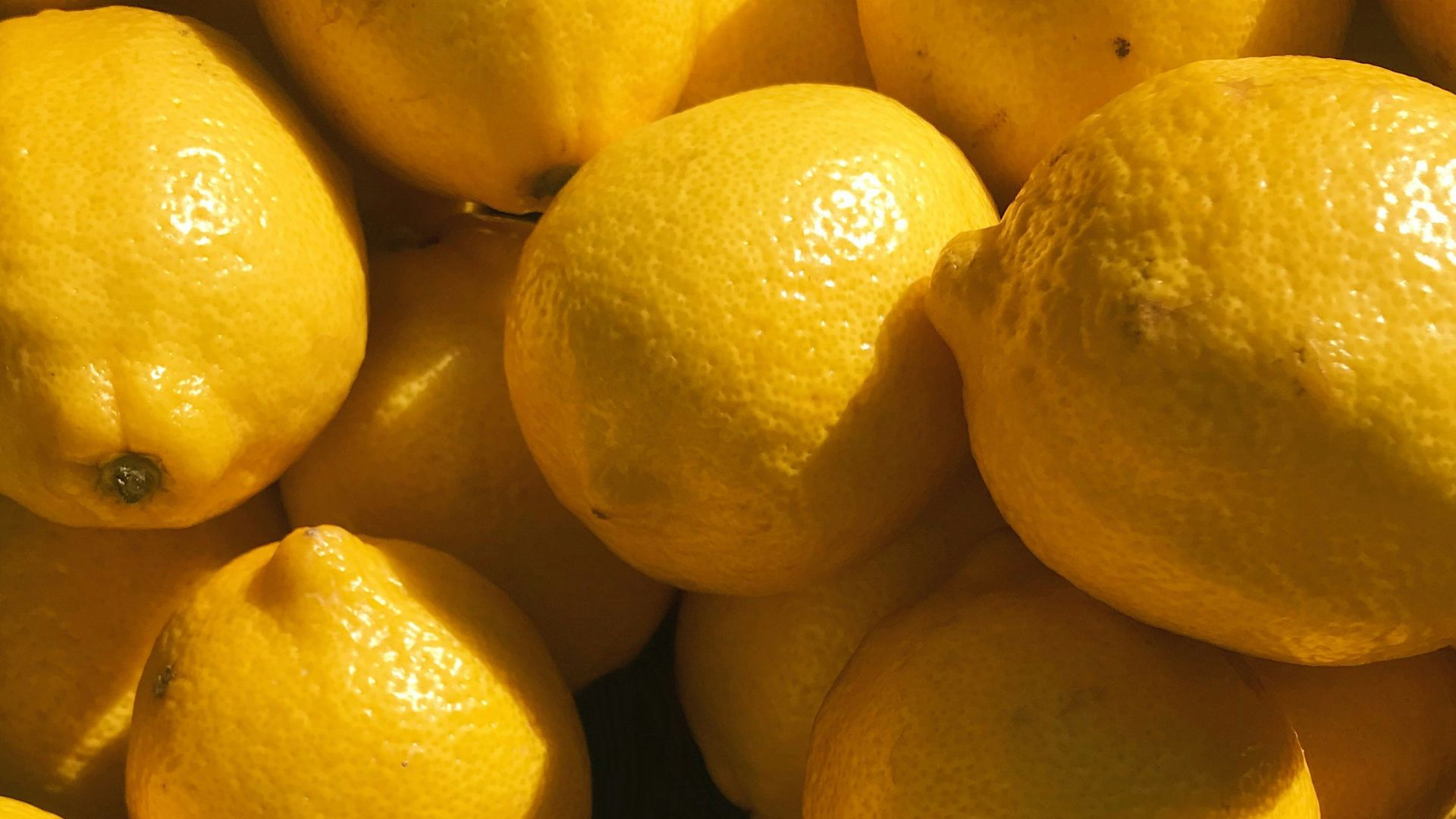 yellow lemon fruits on black surface