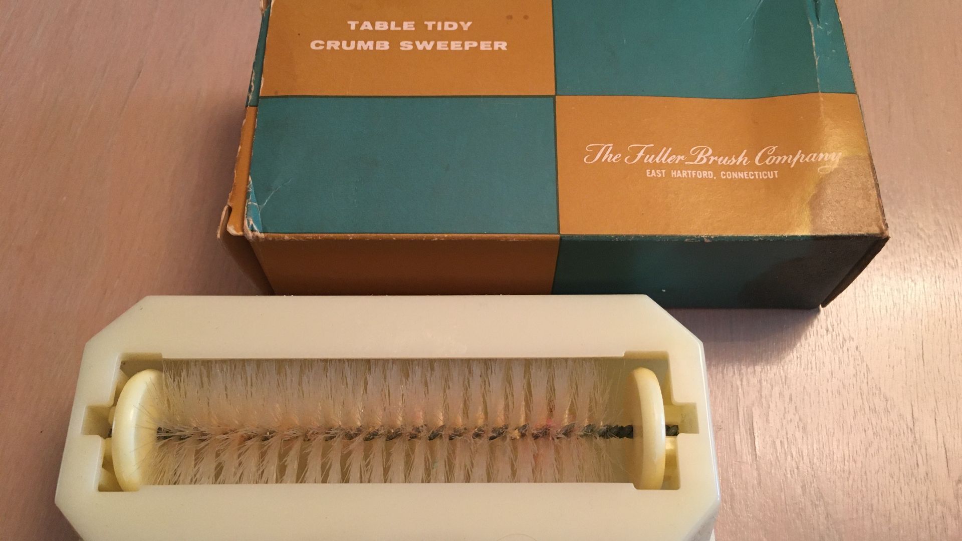 Underside of, and box for, the Table Tidy Crumb Sweeper as sold by The Fuller Brush Company of East Hartford, Connecticut.  Made in U.S.A.  From the 1950s or 1960s.