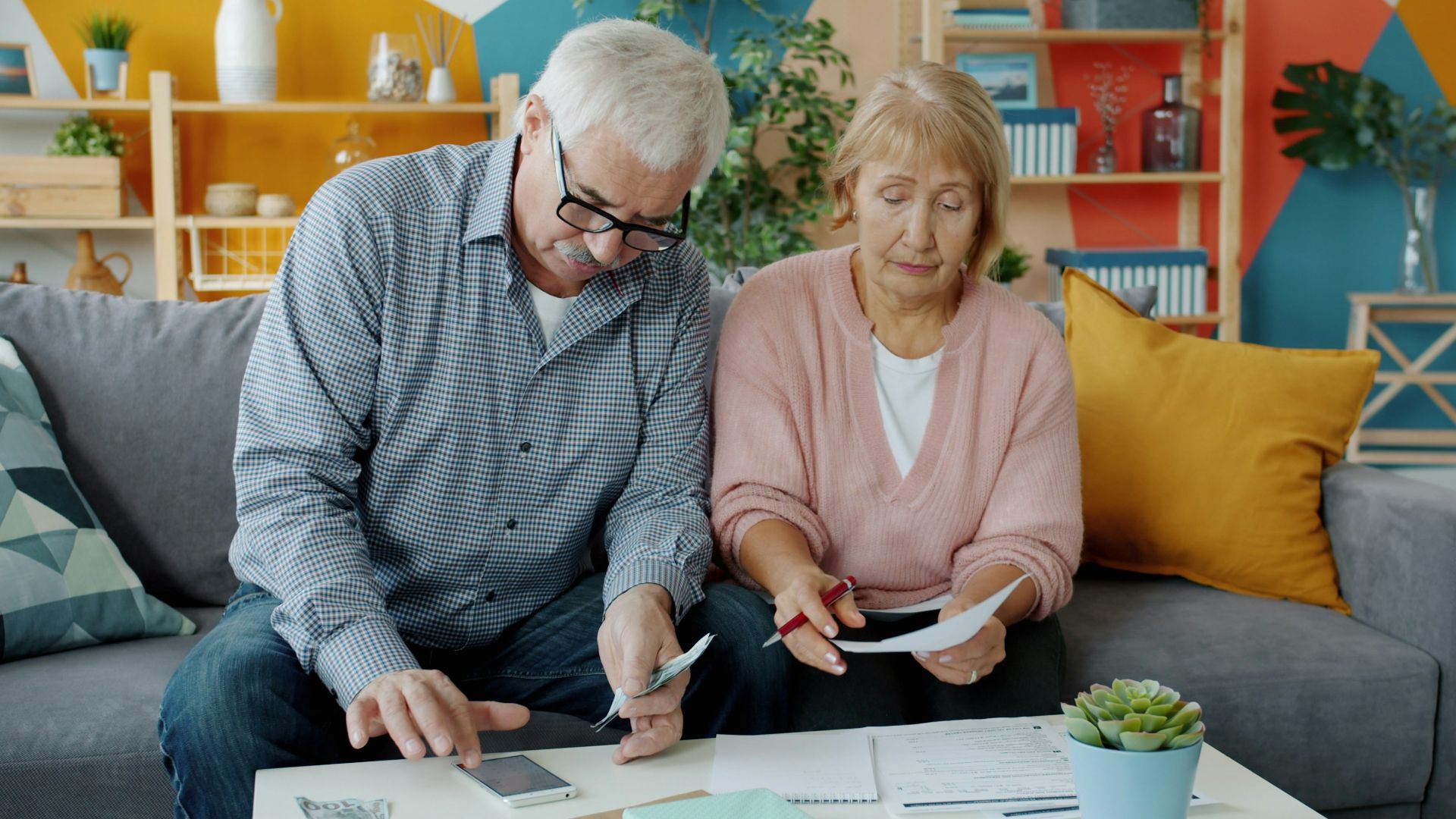 Elderly couple reviewing documents at home