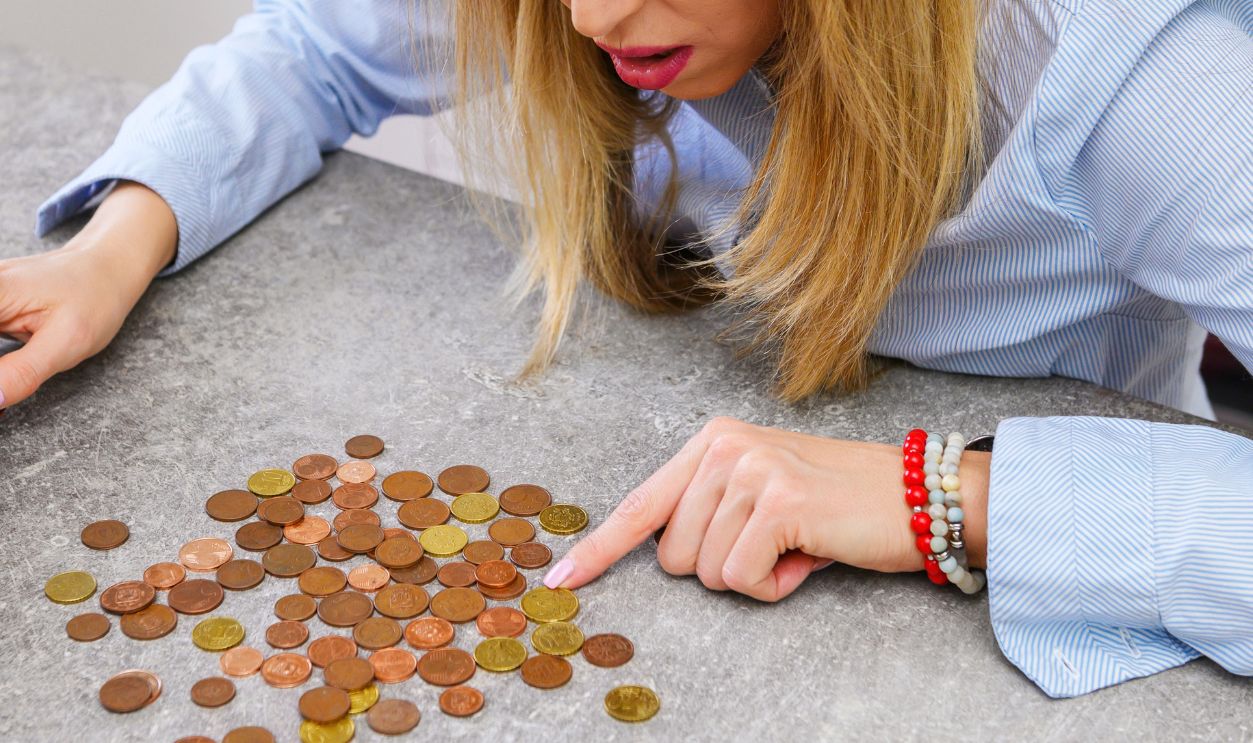 Desperate woman counting last coins
