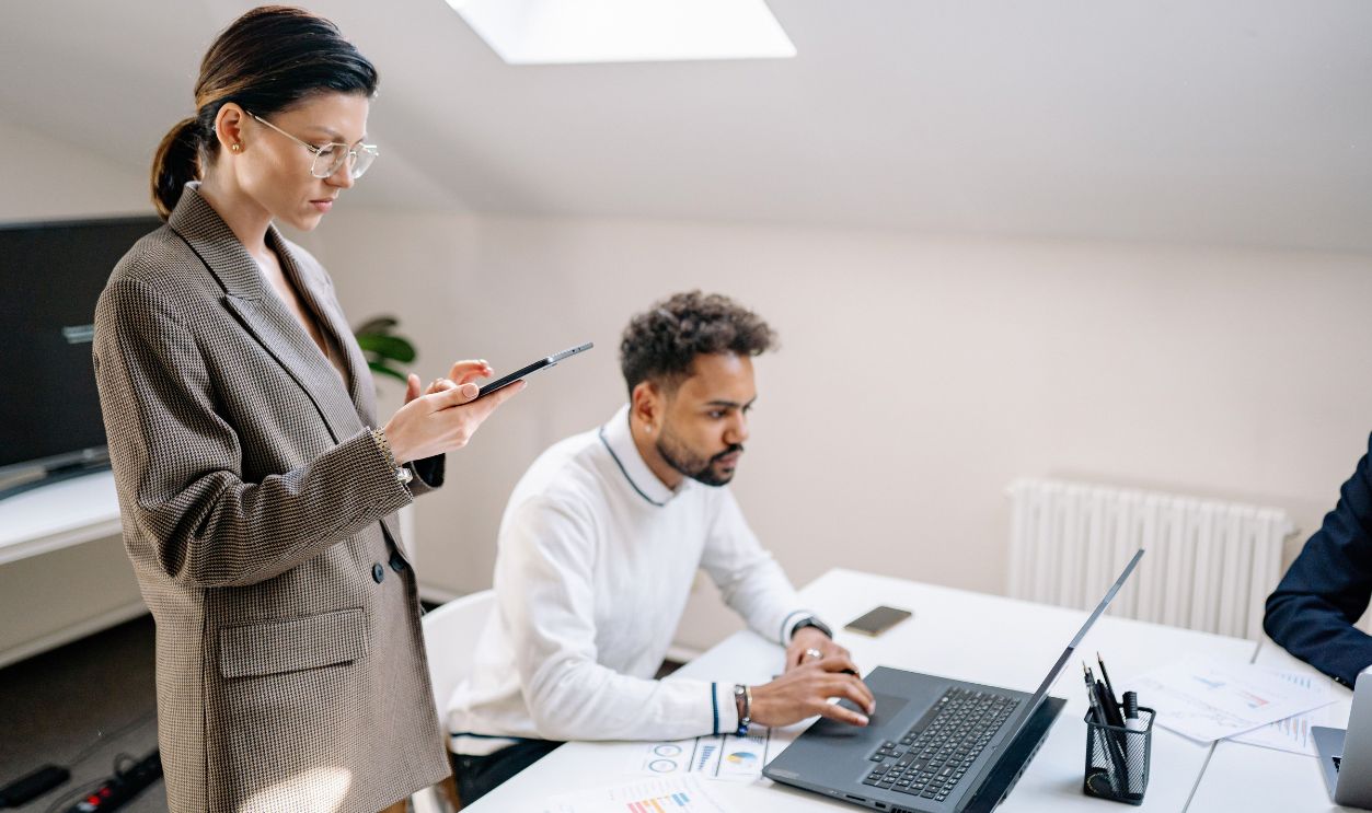 Two colleagues working together in a modern office environment