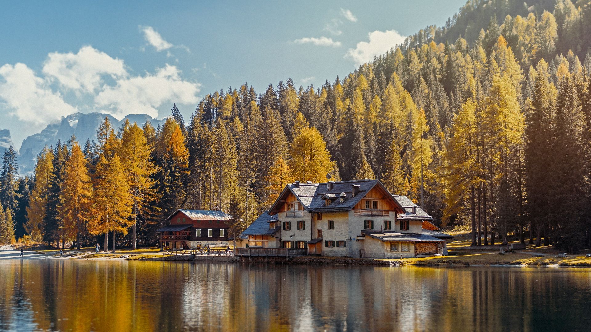 white and brown house near body of water during daytime