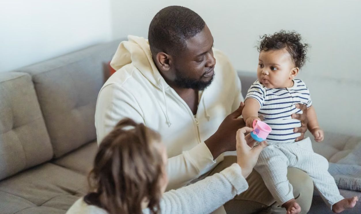 Father and child enjoy a playful moment indoors, highlighting family connection.