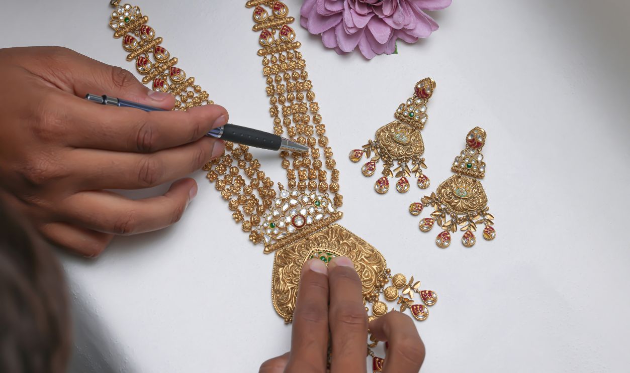 A woman is working on a gold necklace