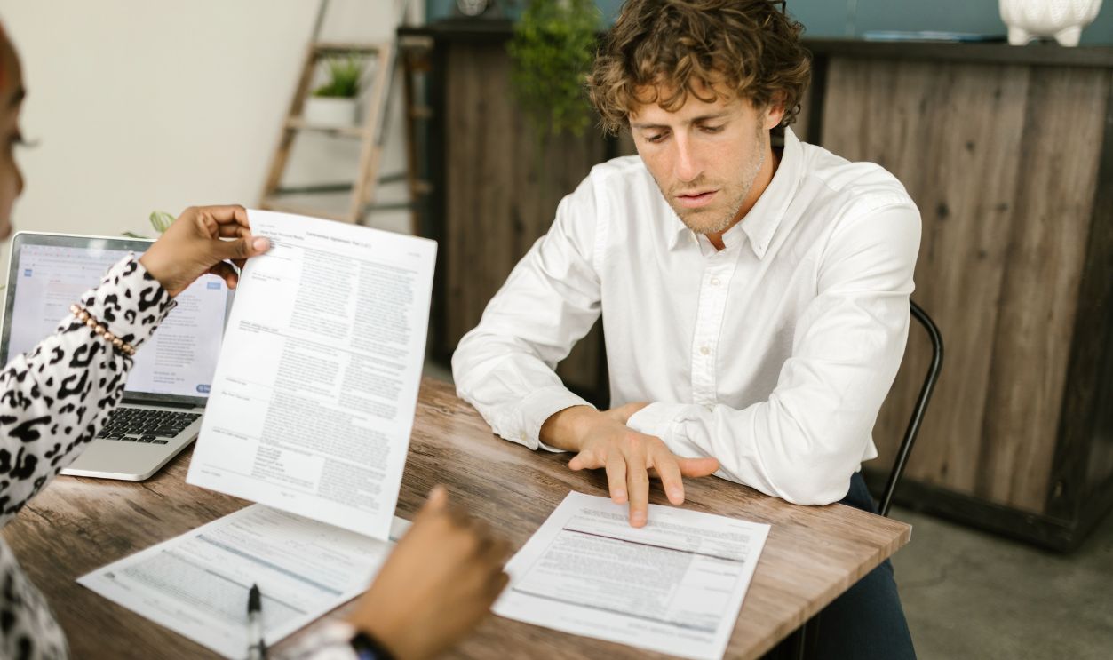 Two professionals reviewing documents in an office setting