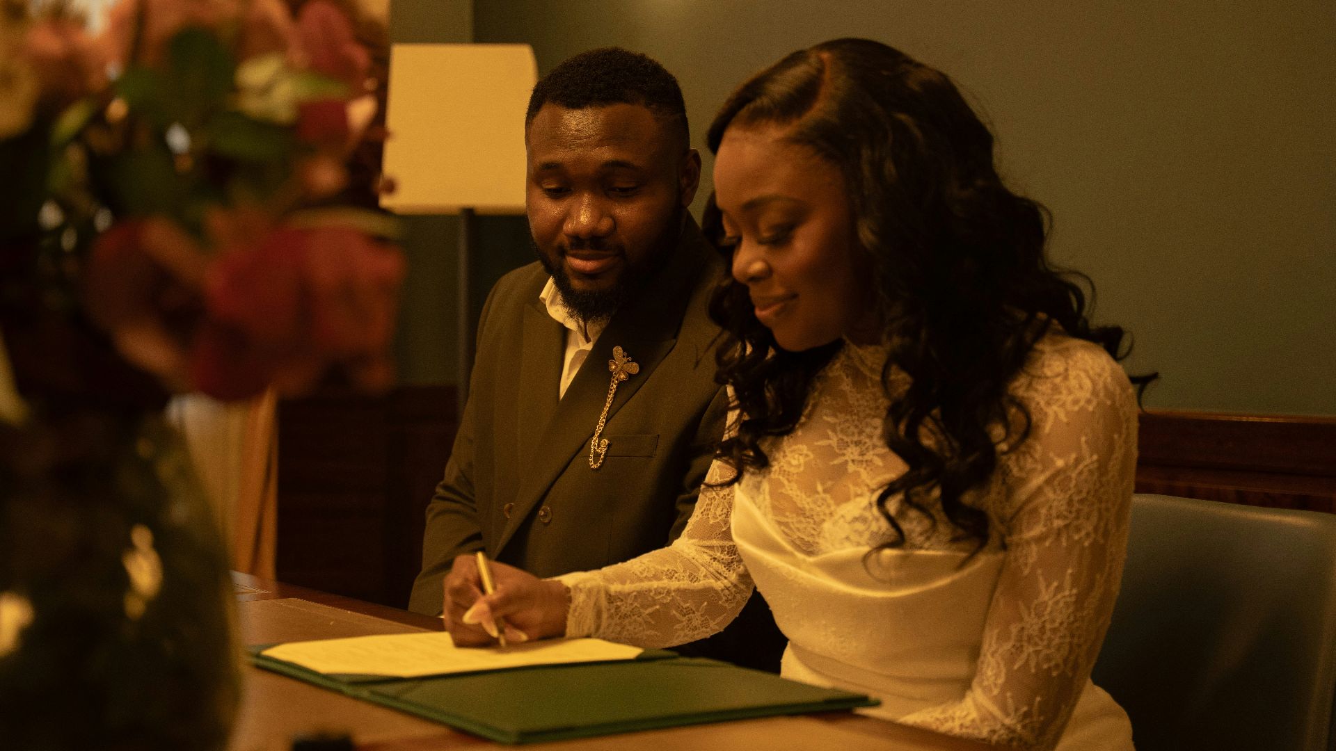 A couple signs their wedding papers