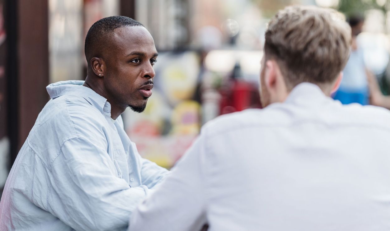 Two men having a conversation in an outdoor setting