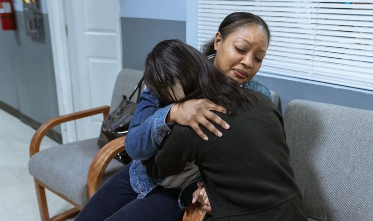women comforting each other