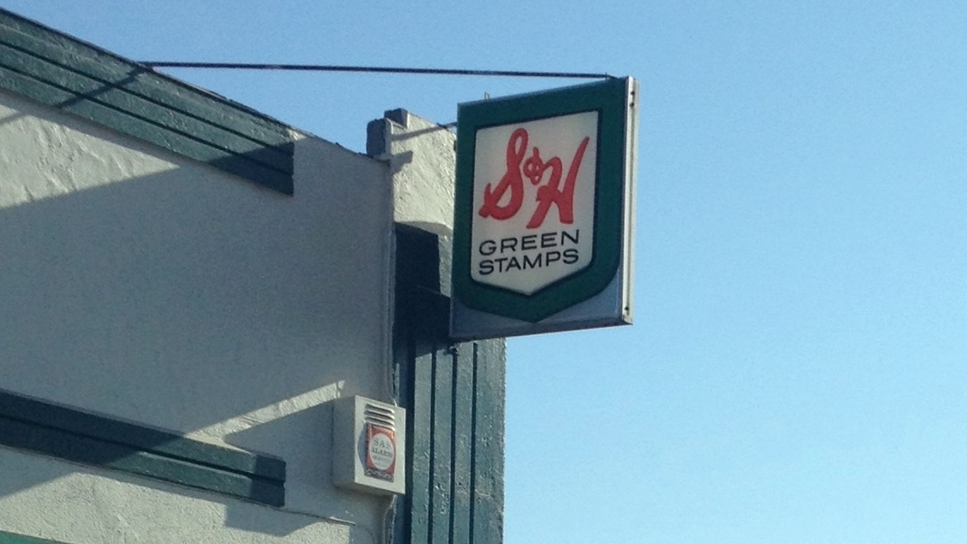An old S&H Green Stamps sign on a grocery store building, preserved for nostalgic/historic value. Santa Cruz Market in Goleta, California.