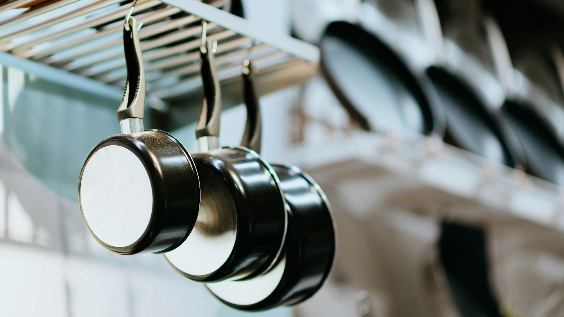 selective focus photography of three frying pans
