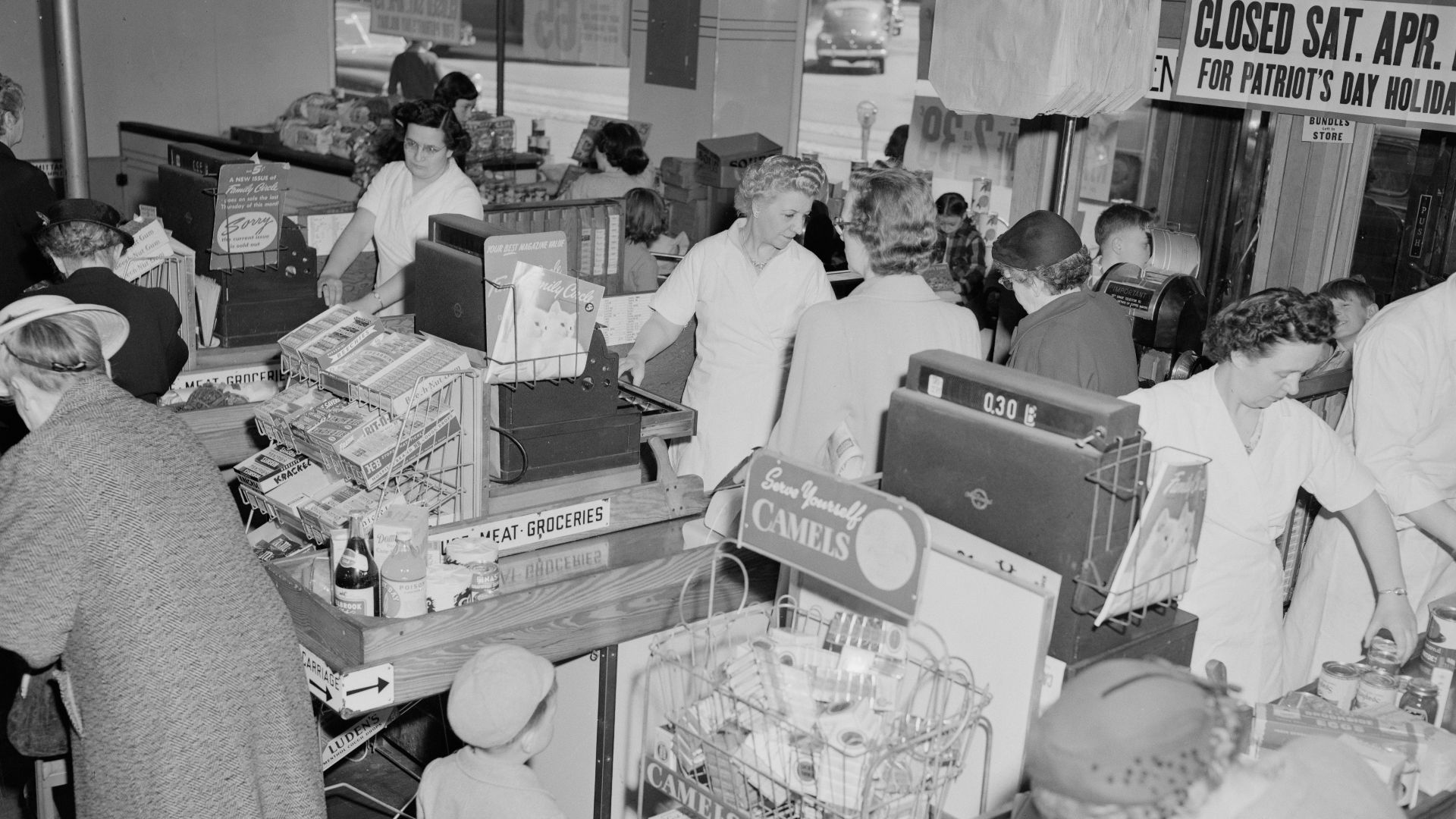grayscale photo of people in store